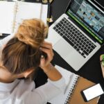 woman sitting in front of macbook