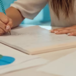 close up shot of a person writing on a paper