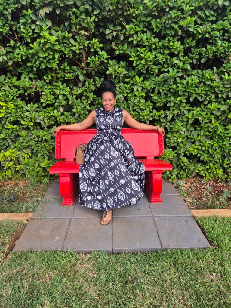 Person sitting on a red bench.