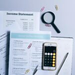 Tax documents and calculator on desk