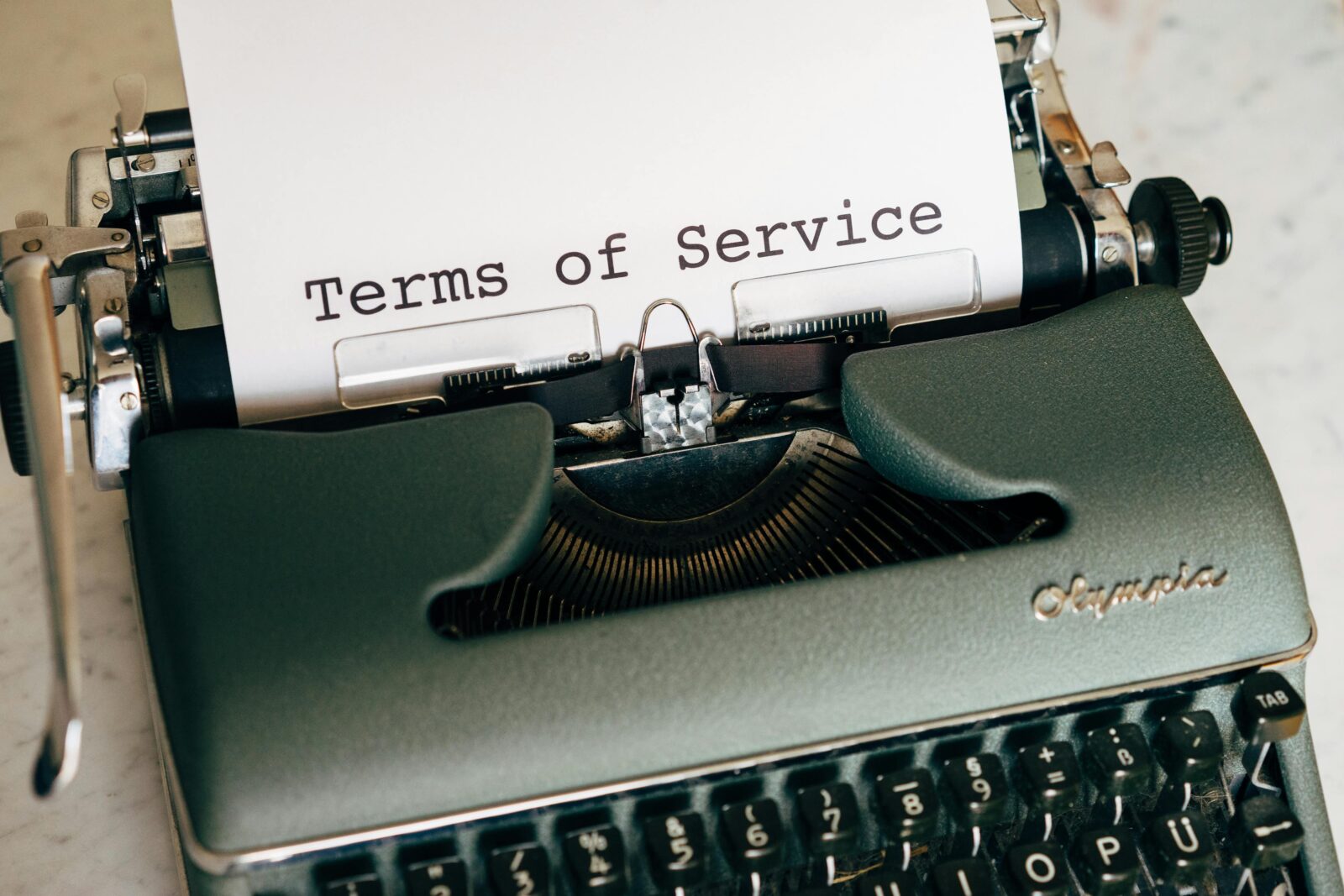 Legal & Policies 1 Close-up of a vintage typewriter printing 'Terms of Service' on paper, ideal for legal and business themes.